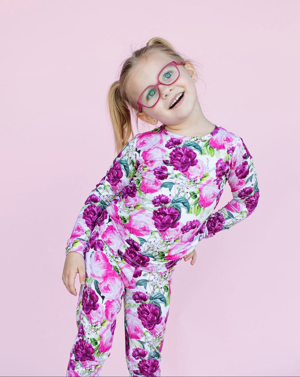 Child wearing a floral pajama on a pink background